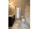 Bright bathroom with a dark vanity, marble floors, and a door to outside at 10411 Riverburn Dr, Tampa, FL 33647