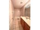 Cozy bathroom featuring tile floors, wooden vanity, and a shower-tub combination at 10411 Riverburn Dr, Tampa, FL 33647