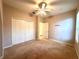 Neutral bedroom with a ceiling fan, closet, light carpet and baseboard trim at 10411 Riverburn Dr, Tampa, FL 33647