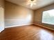 Neutral bedroom with a ceiling fan, light hardwood floors, and baseboard trim at 10411 Riverburn Dr, Tampa, FL 33647