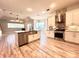 Open kitchen with stainless steel appliances, granite countertops and an island with a farmhouse sink at 10411 Riverburn Dr, Tampa, FL 33647