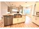 Stylish kitchen with a stainless steel farmhouse sink, granite countertops, and white cabinets at 10411 Riverburn Dr, Tampa, FL 33647