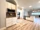 Modern open kitchen with stainless steel appliances, granite countertops, and white cabinetry at 10411 Riverburn Dr, Tampa, FL 33647