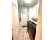 Laundry room with overhead cabinets, granite counters, and black washer and dryer units at 10411 Riverburn Dr, Tampa, FL 33647