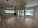 Bright living room featuring wood floors, fireplace and sliding glass doors to screened-in lanai and pool at 10411 Riverburn Dr, Tampa, FL 33647