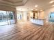 Open concept living area with luxury vinyl plank flooring flowing to a gourmet kitchen and screened lanai at 10411 Riverburn Dr, Tampa, FL 33647