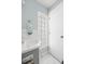 Small bathroom with gray vanity and glass block window at 19718 Gulf Blvd, Indian Shores, FL 33785