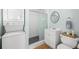 Updated bathroom with shower, vanity, and stackable washer/dryer at 19718 Gulf Blvd, Indian Shores, FL 33785