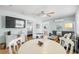 Bright dining area with round table and chairs, open to living room and kitchen at 19718 Gulf Blvd, Indian Shores, FL 33785