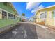 Pathway between colorful beach cottages leading to the ocean at 19718 Gulf Blvd, Indian Shores, FL 33785