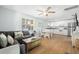 Open living room and kitchen with gray sectional sofa and white cabinets at 19718 Gulf Blvd, Indian Shores, FL 33785