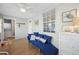 Bright sunroom with comfy seating, wicker chairs, and access to laundry at 19718 Gulf Blvd, Indian Shores, FL 33785