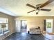 Living room with sliding glass doors leading to a screened porch and tile flooring at 2132 Hailstone Cir # 378, Sun City Center, FL 33573