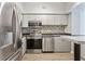 Modern kitchen with stainless steel appliances and light wood flooring at 2411 W Horatio St # 522, Tampa, FL 33609