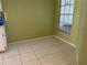 Simple dining area with tile floor and large window at 1070 Seville Dr, Palm Harbor, FL 34684