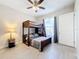 Well-lit bedroom featuring a bunk bed and a full-size bed, offering comfortable sleeping arrangements at 949 Symphony Isles Blvd, Apollo Beach, FL 33572