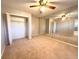 Spacious bedroom with mirrored closet doors and ceiling fan at 10411 Riverburn Dr, Tampa, FL 33647