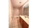 Clean bathroom, featuring a shower/tub combo, toilet and vanity with wood cabinets at 10411 Riverburn Dr, Tampa, FL 33647