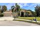 Two-story house with a two-car garage and palm trees at 10411 Riverburn Dr, Tampa, FL 33647