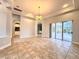 Dining room with access to a pool and a chandelier at 10411 Riverburn Dr, Tampa, FL 33647