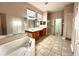 Elegant bathroom with double vanity, soaking tub, and shower at 10411 Riverburn Dr, Tampa, FL 33647