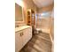 Clean bathroom with a bathtub, shower, and updated vanity at 10411 Riverburn Dr, Tampa, FL 33647