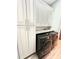 Bright laundry room with stacked washer and dryer at 10411 Riverburn Dr, Tampa, FL 33647