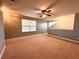 Large bedroom with window, ceiling fan and neutral decor at 10411 Riverburn Dr, Tampa, FL 33647