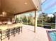 Outdoor kitchen with bar seating and built-in grill at 10411 Riverburn Dr, Tampa, FL 33647