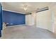 Spacious bedroom with gray carpet and a blue accent wall at 20180 Ragazza Cir # 201, Venice, FL 34293