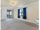 Bright bedroom with gray carpet and private balcony access at 20180 Ragazza Cir # 201, Venice, FL 34293