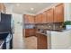 Modern kitchen with granite countertops, wood cabinets, and stainless steel appliances at 20180 Ragazza Cir # 201, Venice, FL 34293