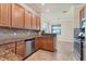 Modern kitchen with granite countertops, wood cabinets, and stainless steel appliances at 20180 Ragazza Cir # 201, Venice, FL 34293