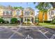 Two-story townhome with yellow siding, landscaping, and driveway parking at 30029 Granda Hills Ct, Wesley Chapel, FL 33543