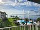 Stunning view of the bay, pool, and lush landscaping from condo balcony at 5155 Isla Key S Blvd # 402, St Petersburg, FL 33715