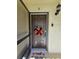 Condo's front door with seasonal decor at 3600 Magnolia Ridge Cir # 1221-G, Palm Harbor, FL 34684