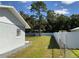 Side yard with large tree and privacy fence at 12612 Litewood Dr, Hudson, FL 34669