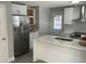 Modern kitchen with stainless steel appliances and white shaker cabinets at 12612 Litewood Dr, Hudson, FL 34669