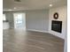 Open concept living room with a fireplace, kitchen view and access to sunroom at 12612 Litewood Dr, Hudson, FL 34669