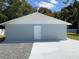 Detached garage with new paint and gravel driveway at 12612 Litewood Dr, Hudson, FL 34669