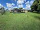 Large backyard with screened patio and lush lawn at 4172 Glade Rd, Spring Hill, FL 34606