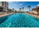 Sparkling community swimming pool with surrounding lounge chairs and patio area at 6294 Bahia Del Mar Cir # 103, St Petersburg, FL 33715