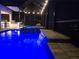 Night view of a luxurious pool with a spa and waterfall feature at 6222 113Th E Ter, Parrish, FL 34219