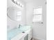 Modern bathroom with a glass vanity top and updated fixtures at 404 E Morgan St, Brandon, FL 33510