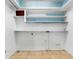 Laundry room with built-in shelving and blue mosaic backsplash at 404 E Morgan St, Brandon, FL 33510