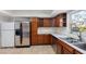Kitchen with wood cabinets, stainless steel appliances, and tile floor at 404 E Morgan St, Brandon, FL 33510