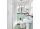 Retro bathroom with mint green tile and white vanity at 404 E Morgan St, Brandon, FL 33510