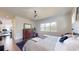 Main bedroom with king bed, hardwood floors, and a view of the home office at 3307 W Wisconsin Ave, Tampa, FL 33611