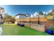 Landscaped backyard with artificial turf, raised garden beds, and a wooden bench at 3307 W Wisconsin Ave, Tampa, FL 33611