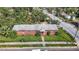 Aerial view of a brick home with a spacious yard and street parking at 3420 E 21St Ave, Tampa, FL 33605